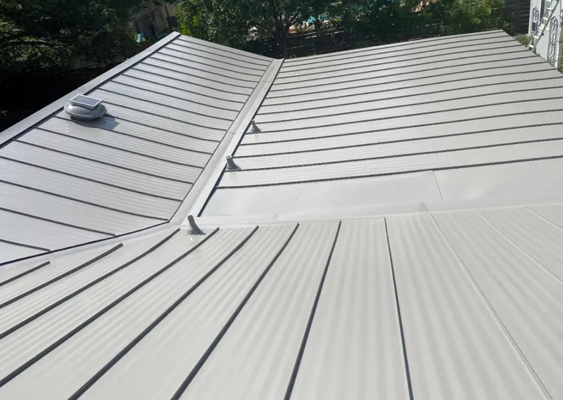Solar attic fan installed on a metal roof for Roof Ventilation in Tell City
